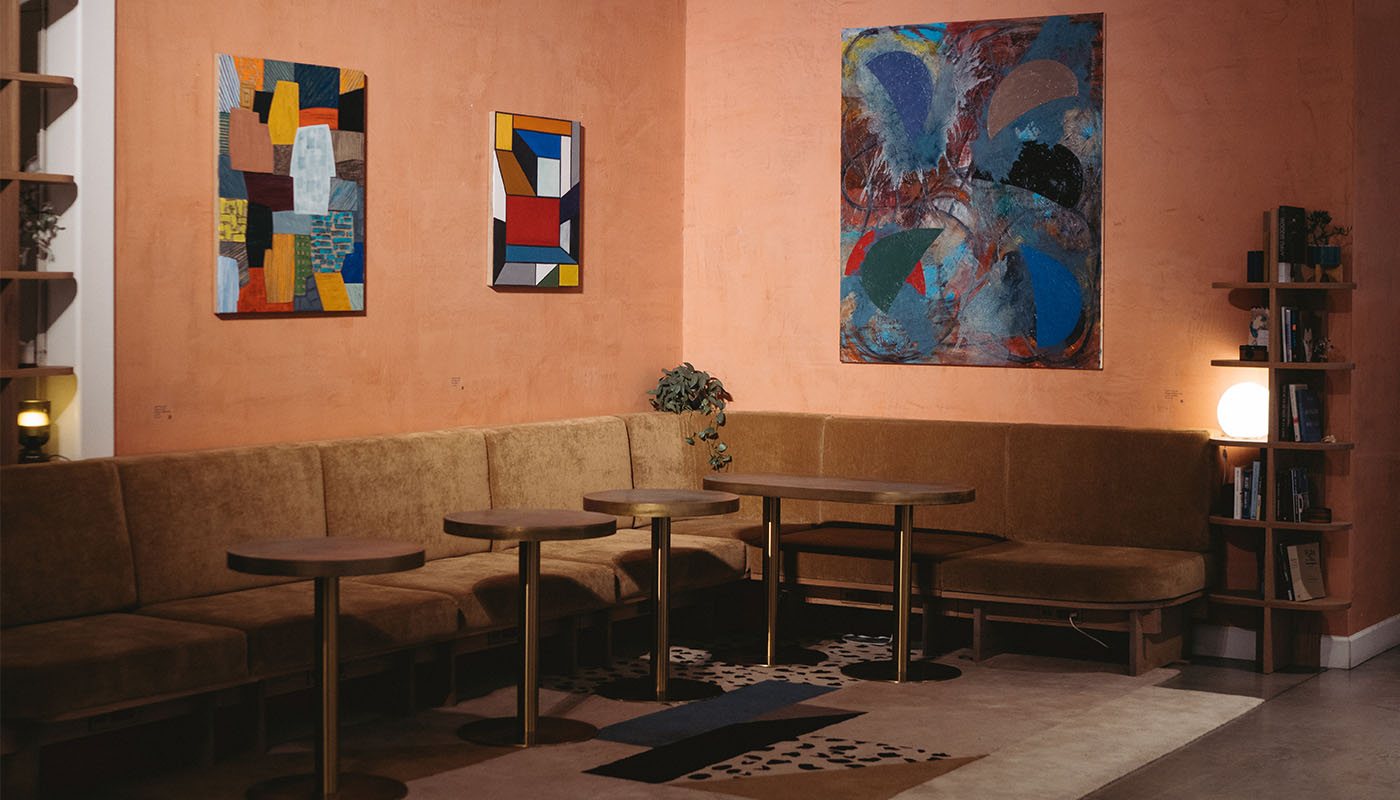 Clubhouse banquette seating beneath the gallery wall