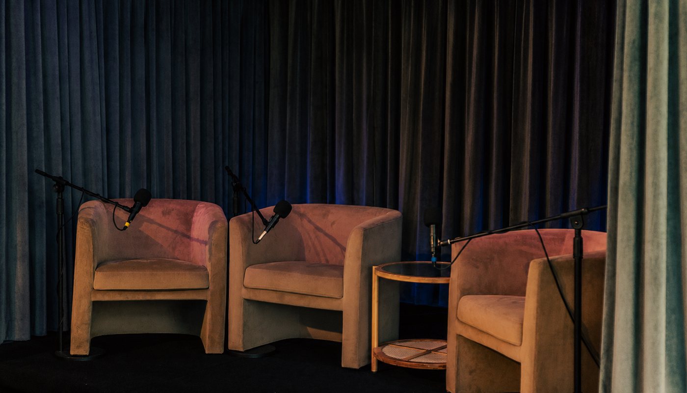 The Clubhouse stage set with lounge chairs for a panel