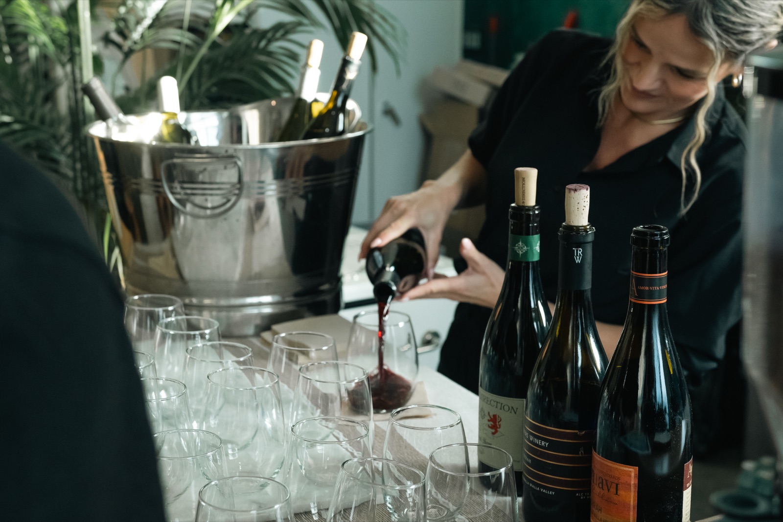 A member of the catering team pouring wine at an event at The KINN